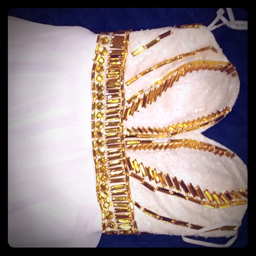 It's a dress probably size 10 it's white with gold